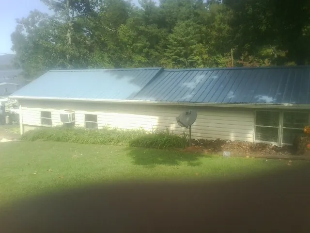 Blue metal roof running the length of a single story home in Woodburn